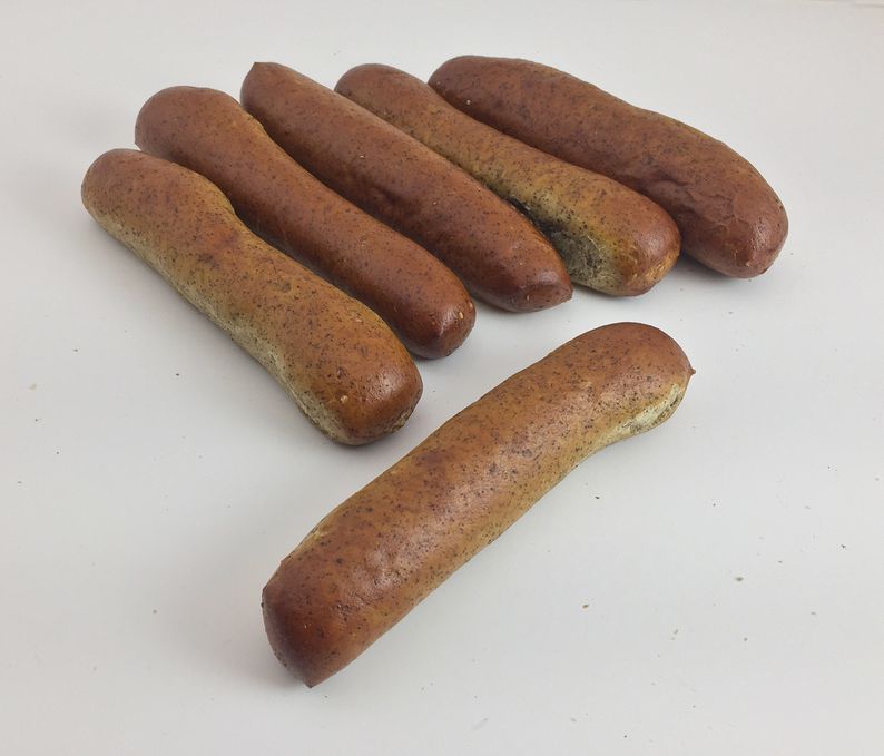 Hot Soft Pretzel Rods no salt, brown and are standard size lined up with one laying cross ways.