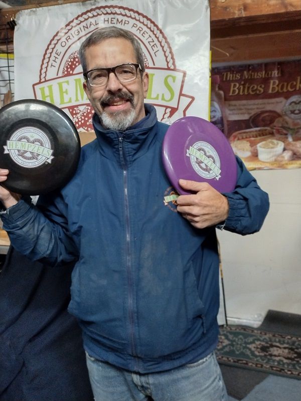 CEO Shawn House of the Lancaster Trading House, Inc holding up examples of carbon negative frisbees