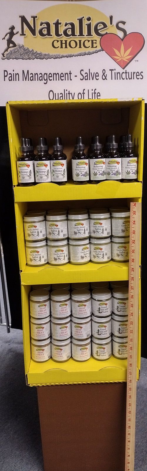 NataliesChoice(tm) yellow bright display with topicals and tincture bottles on it, 3 shelves.