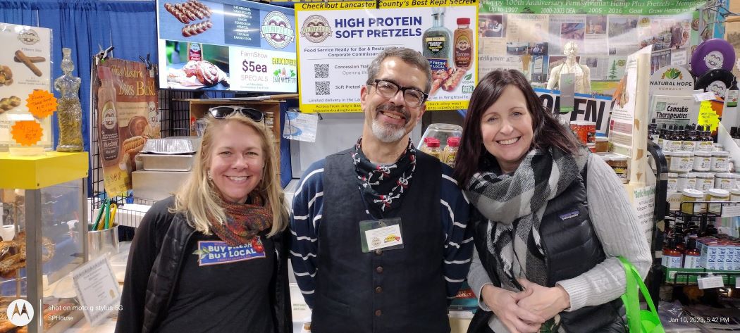 PA Farm show booth with Shawn House & two Representatives from Western PA Farm to table.