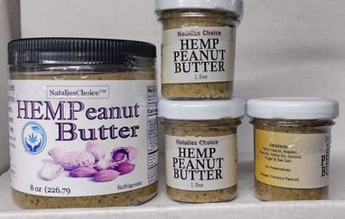 Brown jar with gold lid filled with Hemp Peanut Butter tilted.