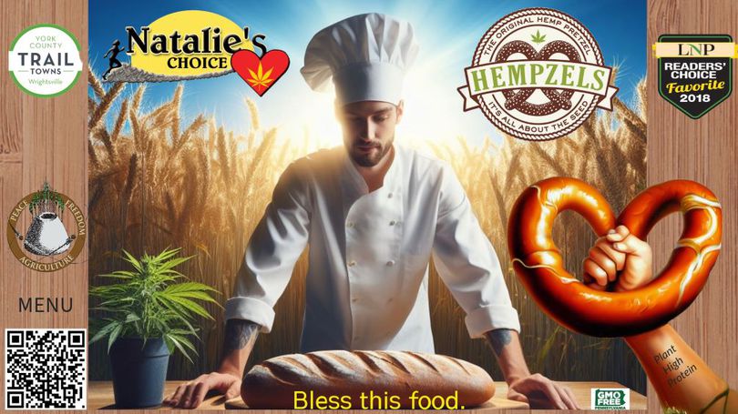Man dressed as chef in wheat field with logos and a giant prertzl thrust out of the lower right hand corner.