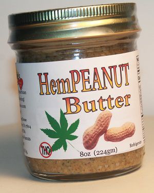 Brown with white label jar of Hempeanut Butter with gold lid.