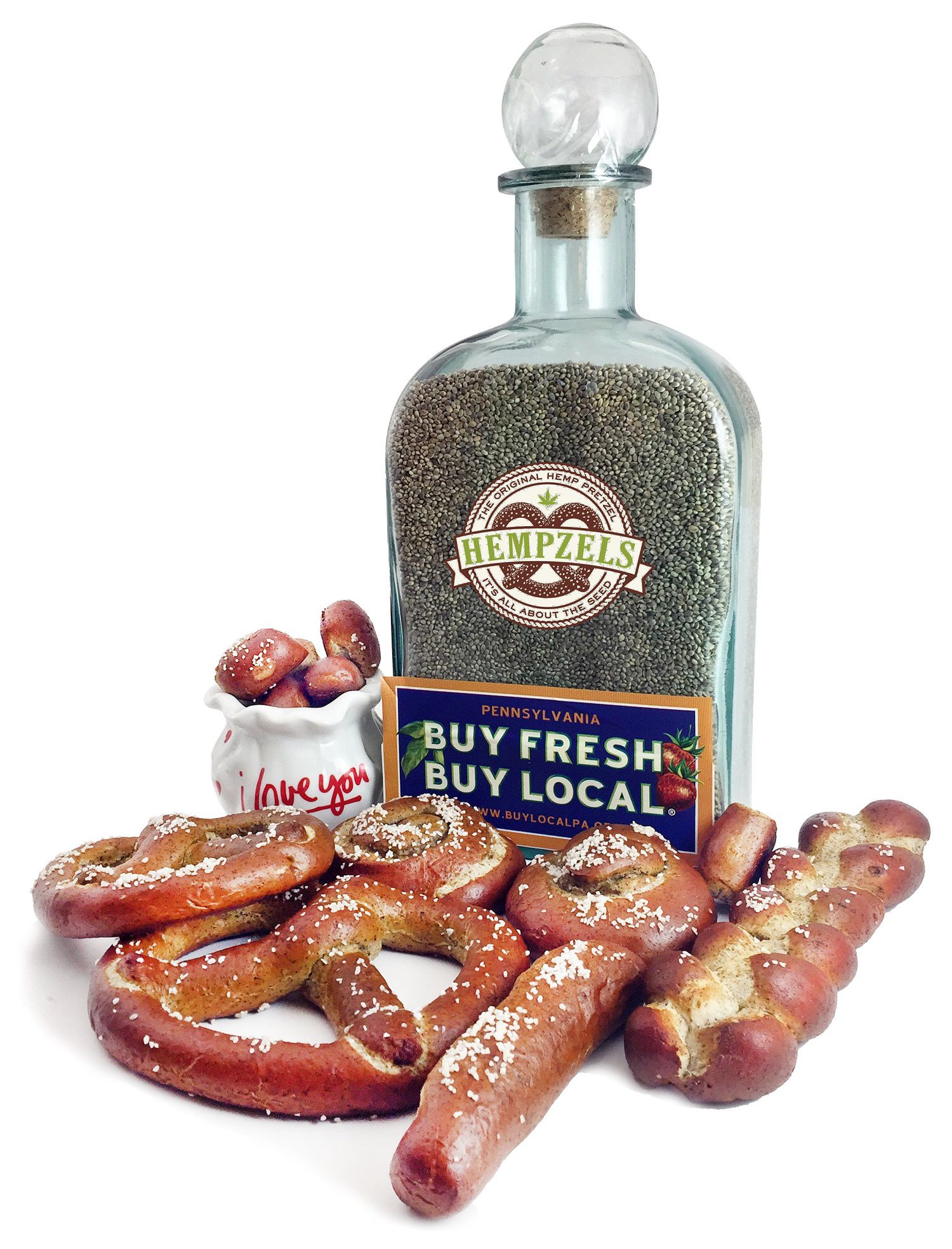 Red smokey background with highlights and spotlight on soft unsalted soft pretzel rods with a pallet of cases and the Hempels logo.