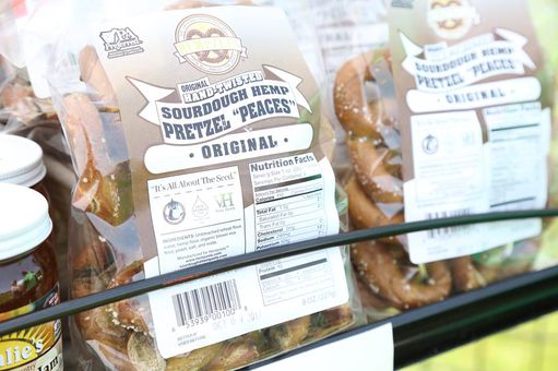 Sourdough Pretzels in clear bags with labels sit in wire rack shelf awaiting purchase.