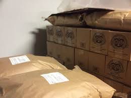 Cases of Hempzels Mustard on a pallet along with hemp flour in 50lb bags stacked in cold storage.