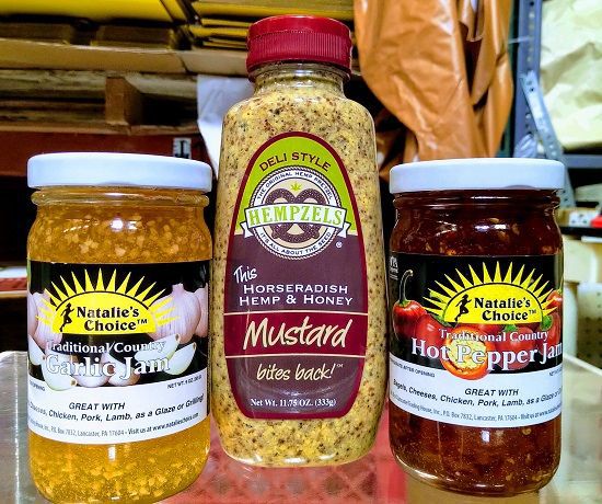 Color image of two jars of jam and one bottle of our Mustard That bites back great with our soft pretzels a great threesome.