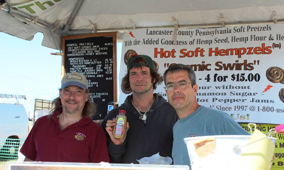 Les Stark in burgandy shirt, friend Lazlo with ball cap and owner Shawn House under the tent booth for Hempzels(tm).