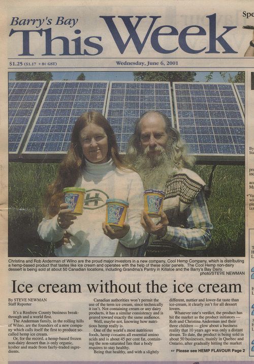 Christina and Rob Andermann holding their CoolHemp(tm) in front of solar panels.